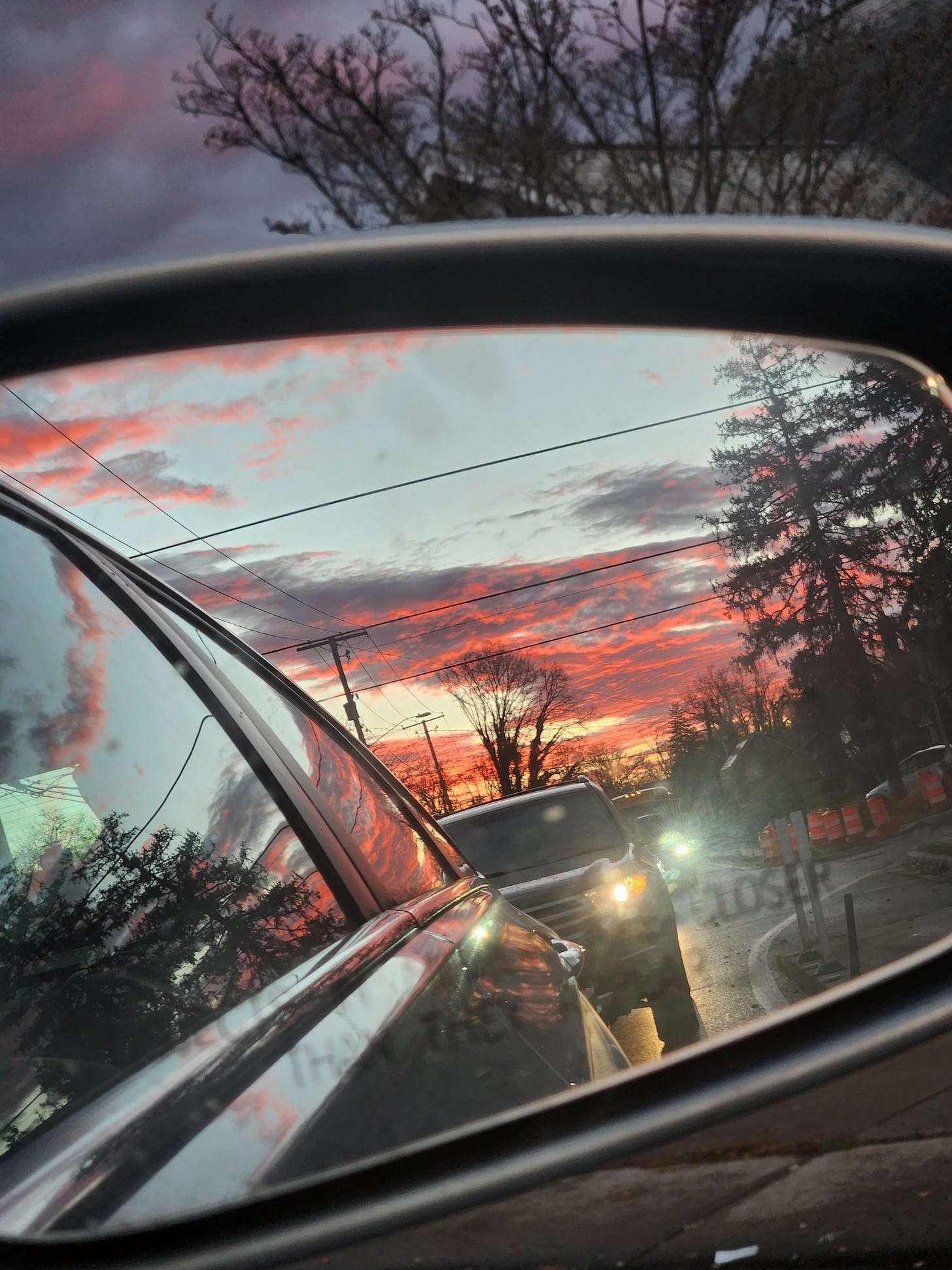sunset in the side mirror of a car