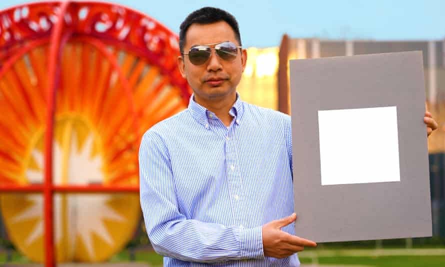Prof Xiulin Ruan, a professor of mechanical engineering, with a sample of the paint.