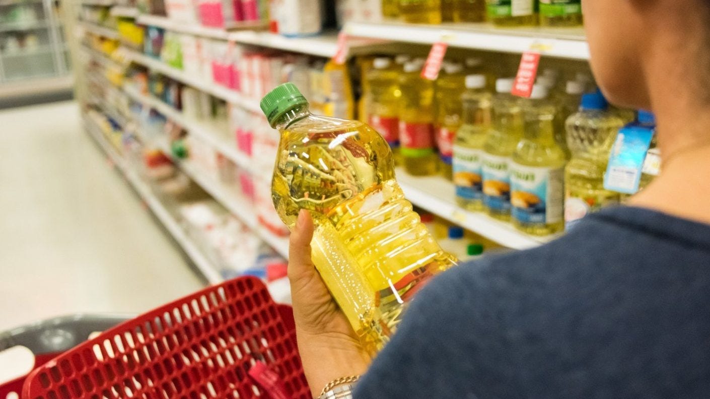 woman-looks-at-oil-packaging-in-grocery-store-march-21-2022-e1648567958835-1410x0-c-default.jpg