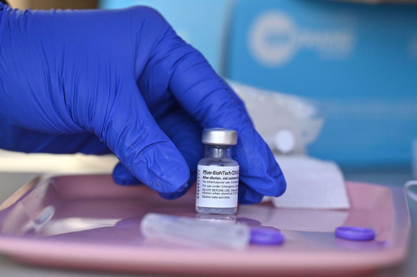 A nurse reached for a vial of Pfizer's COVID-19 vaccine in Los Angeles.