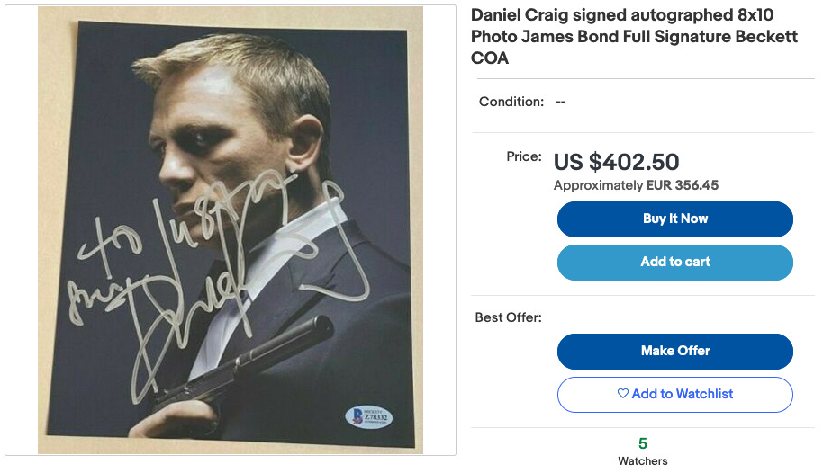 A screenshot of an eBay auction showing a signed photograph of Daniel Craig as James Bond for sale