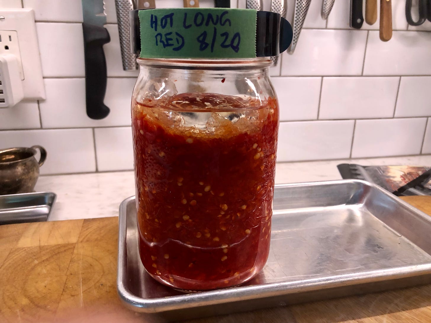 A jar of red chile mash labelled Hot Red Long 8/20