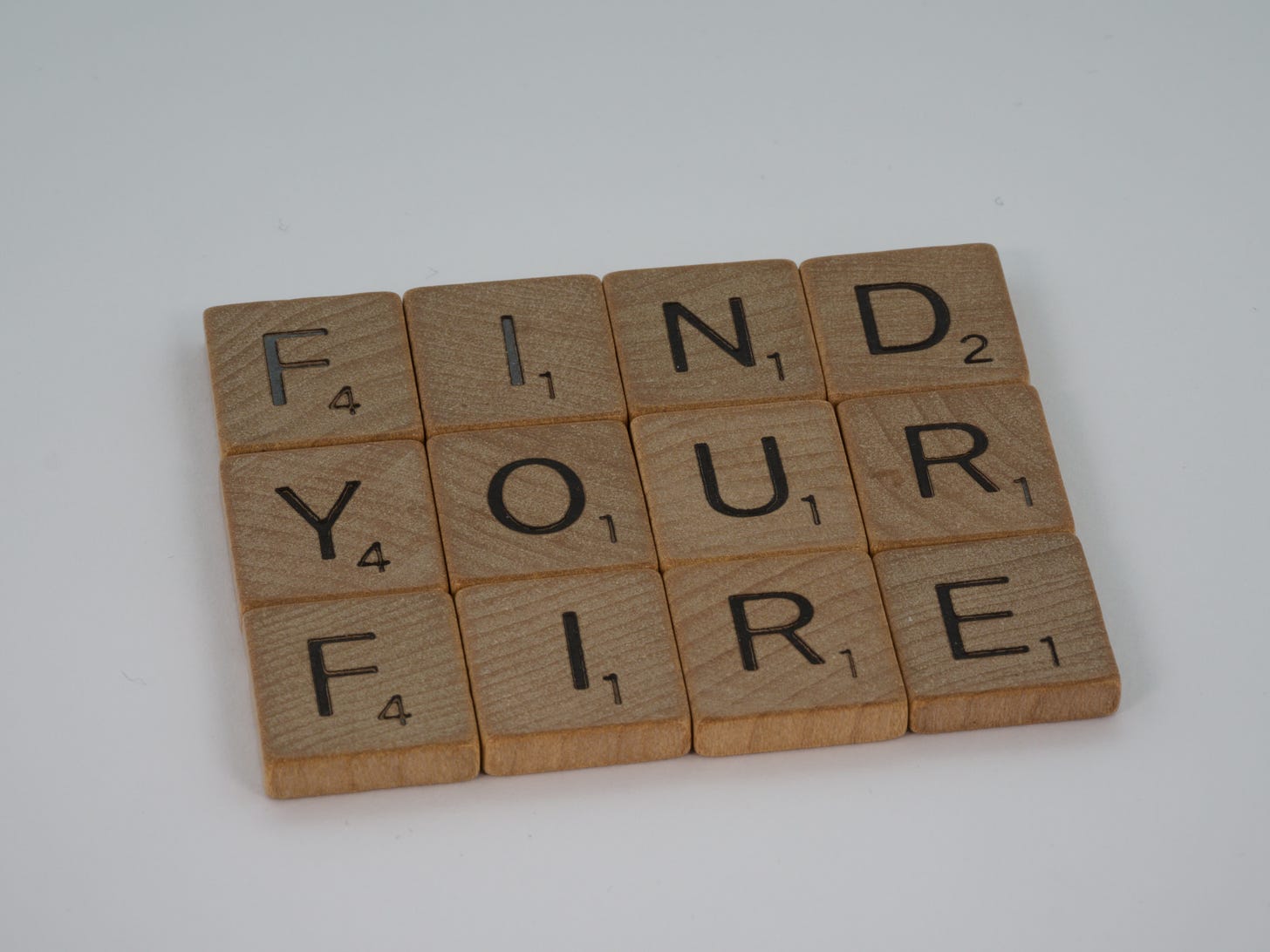 scrabble tiles that read "find your fire"