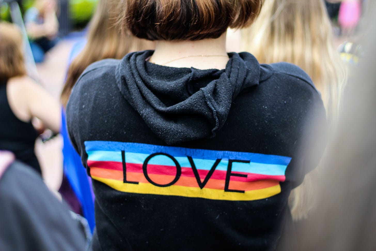 woman in black and multicolored love print hoodie