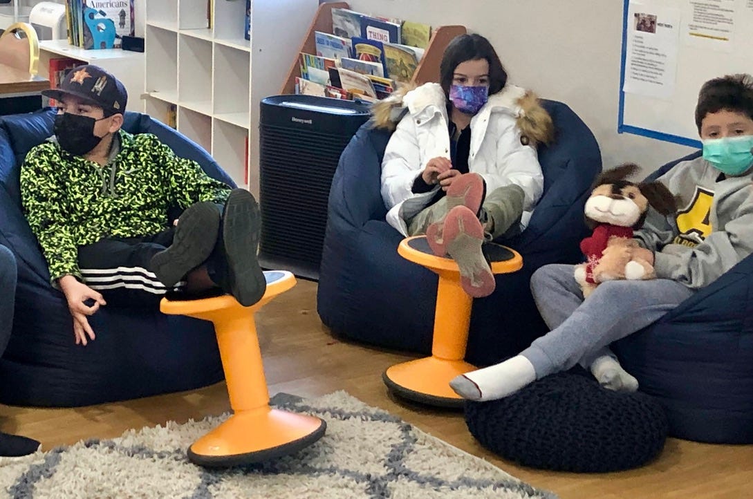 students sitting on beanbag with wiggle stools