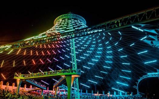 Upward view of U.S. Pavilion in Spokane's Riverfront Park, with rainbow-colored light show.