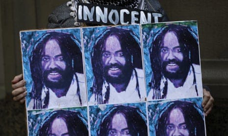 A protester holds up a poster depicting Mumia Abu-Jamal in Philadelphia.