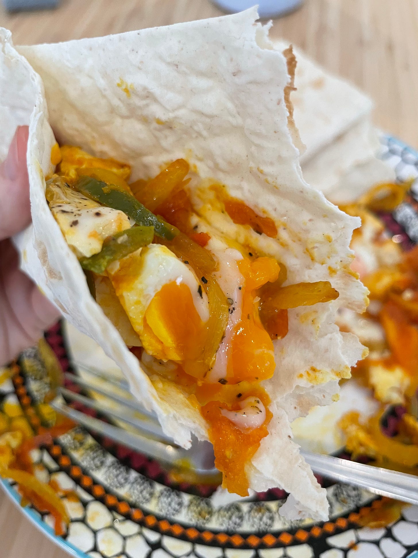 fried eggs with tomatoes and jalapenos in lavash bread