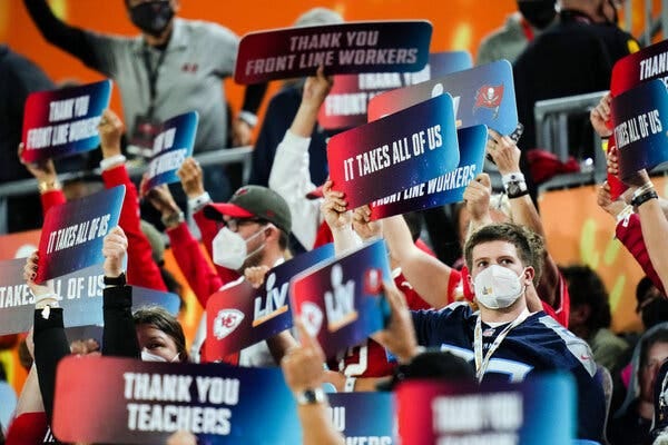 Masked fans paid tribute to front line workers and displayed messages of racial unity during the second quarter of the Super Bowl.