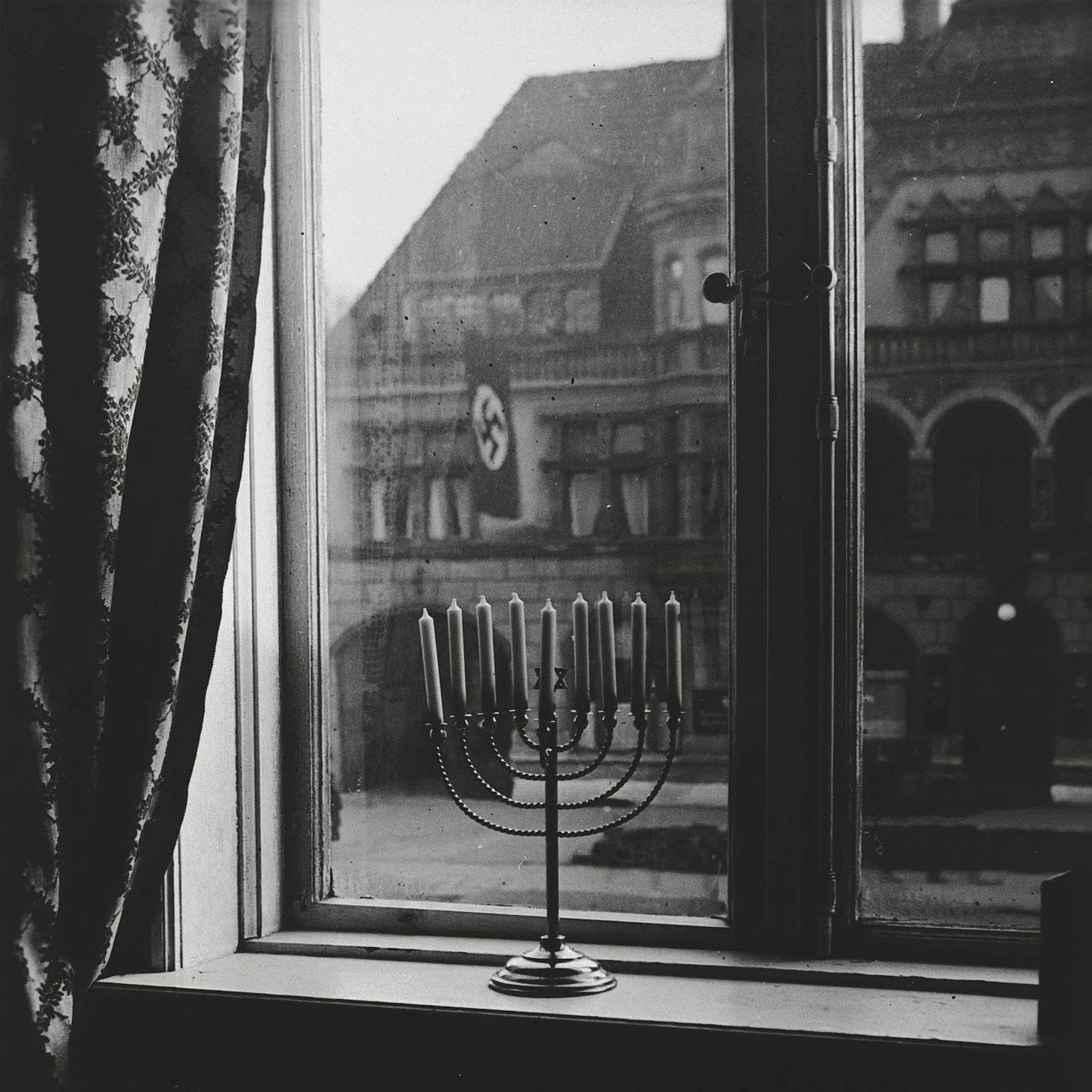 A photo taken in Germany in 1931. On the back of the photo, the rabbi's  wife (Rachel Posner) wrote, "'Death to Judah' so the flag says, 'Judah will  live forever,' so the