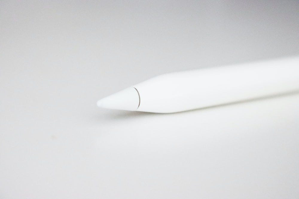 white pen on white table