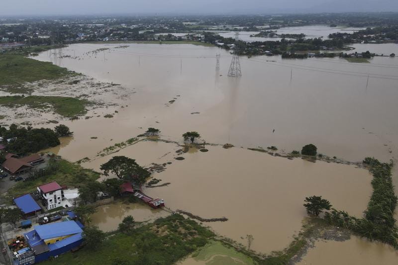 Flooded area due to Typhoon Noru in San Miguel town, Bulacan province, Philippines, Monday, Sept. 26, 2022. Typhoon Noru blew out of the northern Philippines on Monday, leaving some people dead, causing floods and power outages and forcing officials to suspend classes and government work in the capital and outlying provinces. (AP Photo/Aaron Favila)