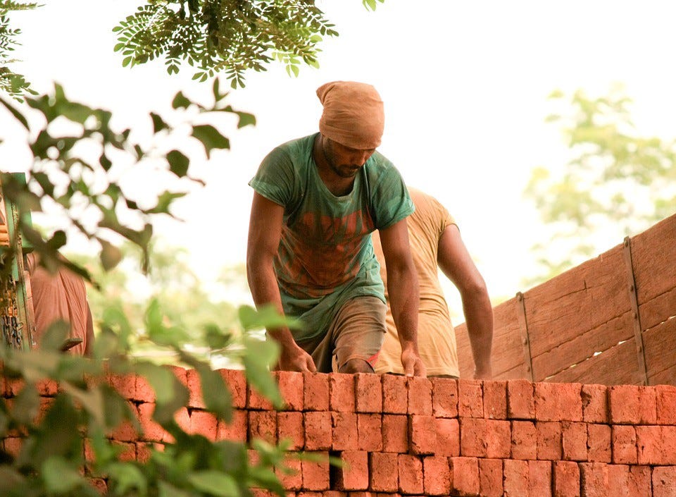 Bricklayer in India. Source: https://www.maxpixel.net/Loading-Bricks-Indian-Labour-Truck-Labourer-166919