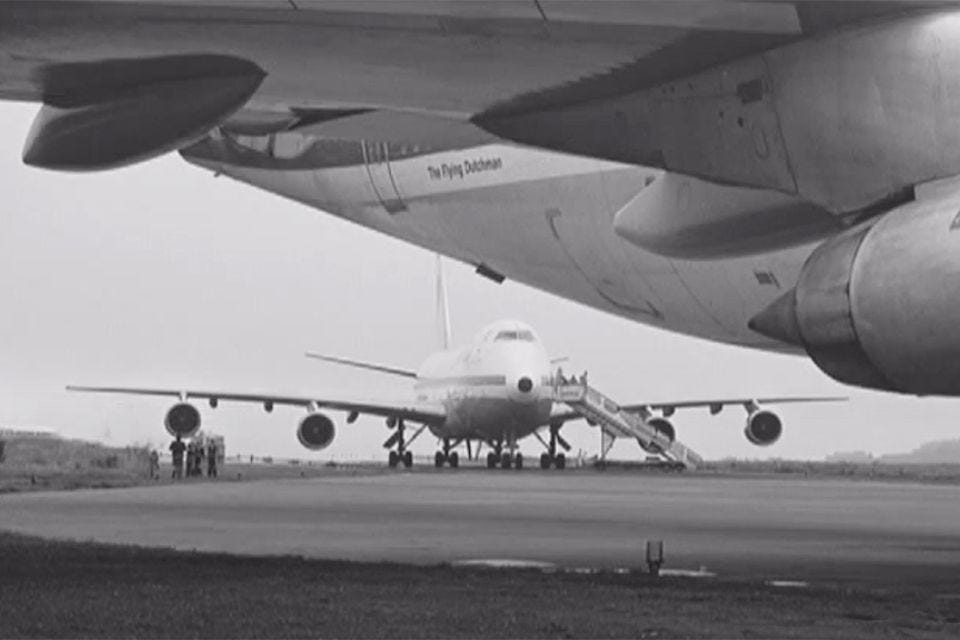 A photo of the rear of KLM 4805, in the foreground, and Pan-Am 1736, in the centre, at Los Rodeos airport on the day of the accident.