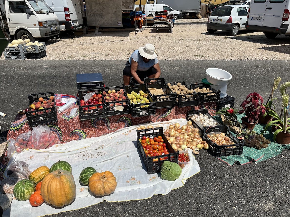 A small farm vendor displays her fresh produce for sale