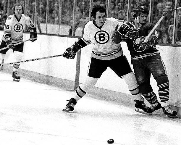 Brad Park of the Boston Bruins skates against Danny Gare of the Buffalo Sabres in game at the Boston Garden.