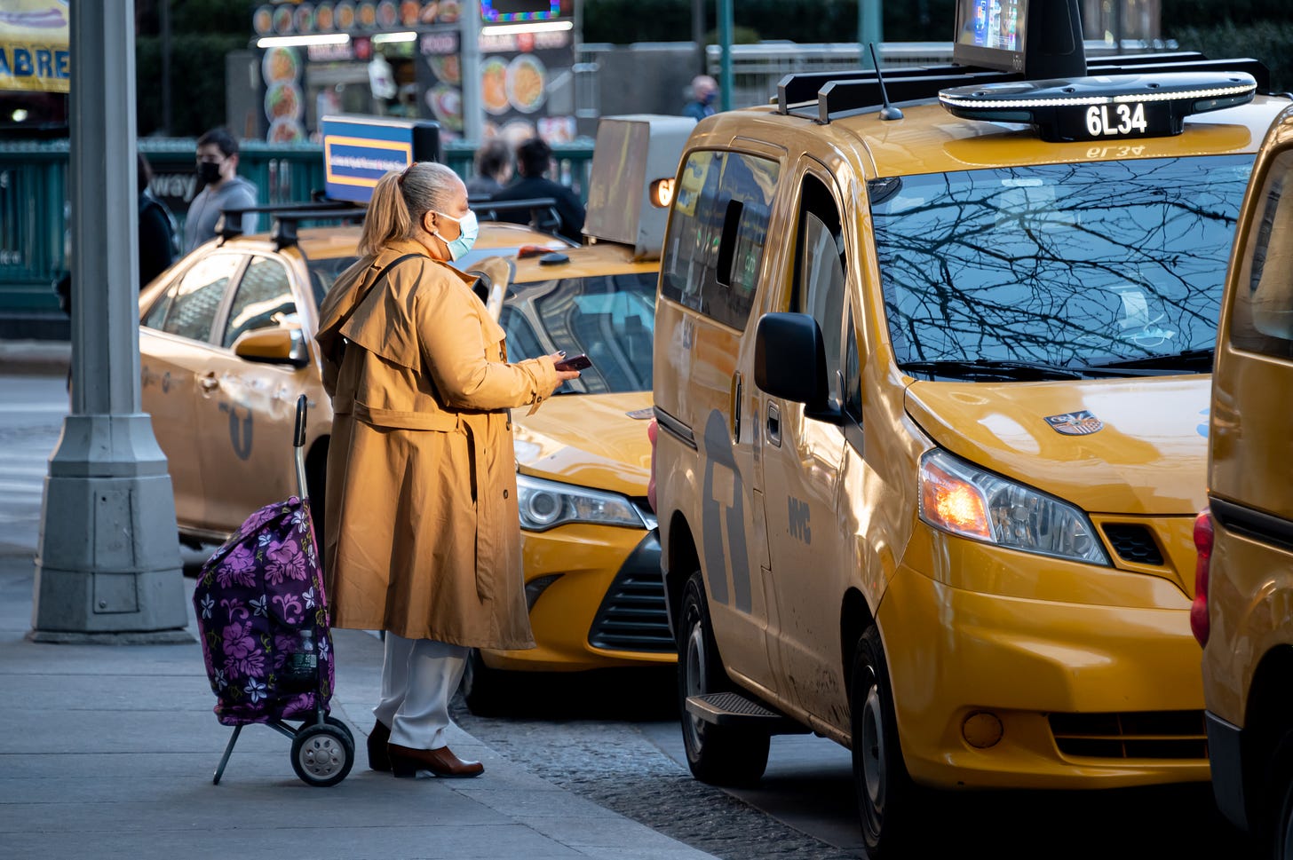 A rider enters a yellow cab in New York City in March 2021.