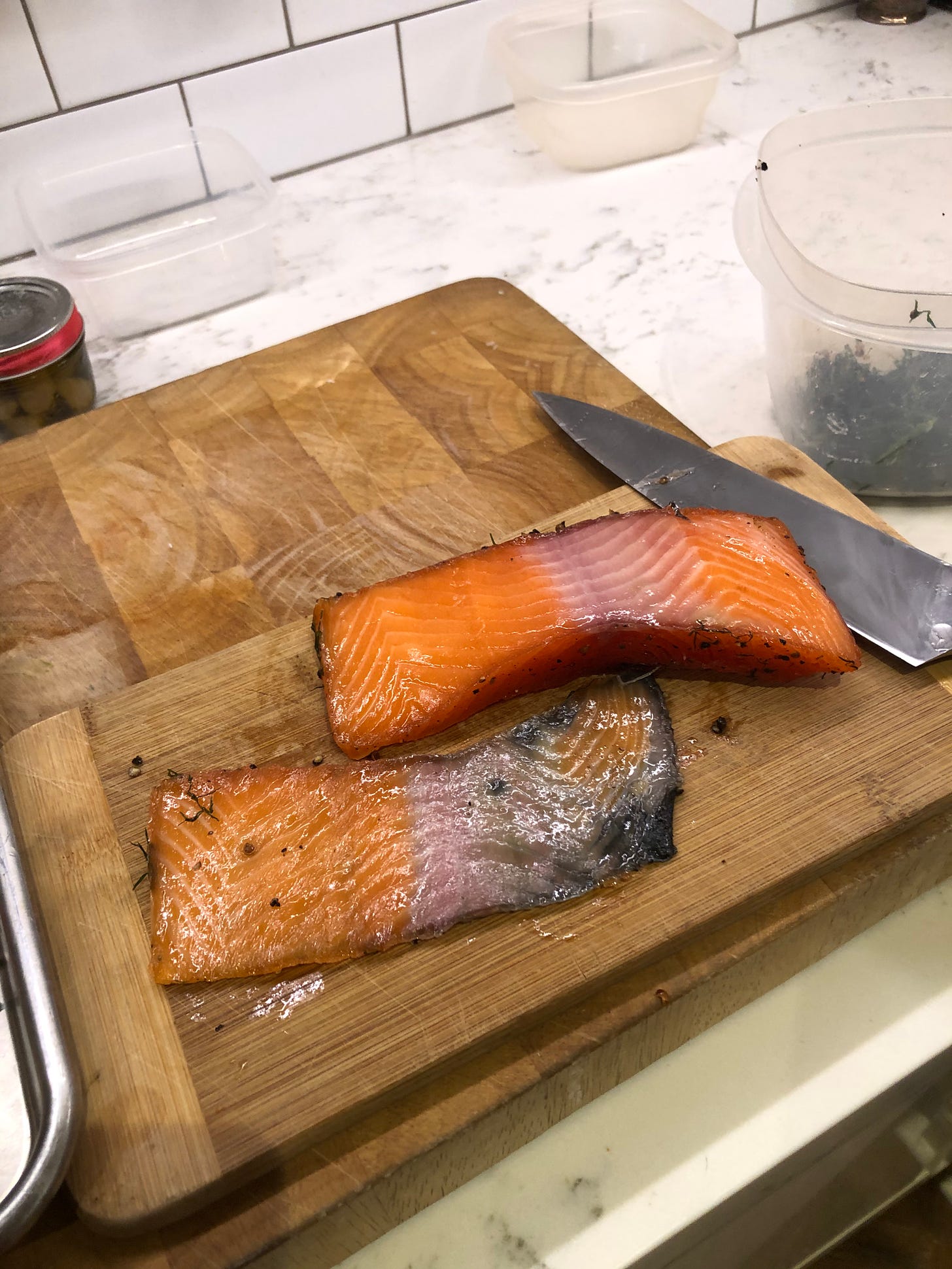 A piece of gravlax with the skin removed. A little flesh remains on the skin.