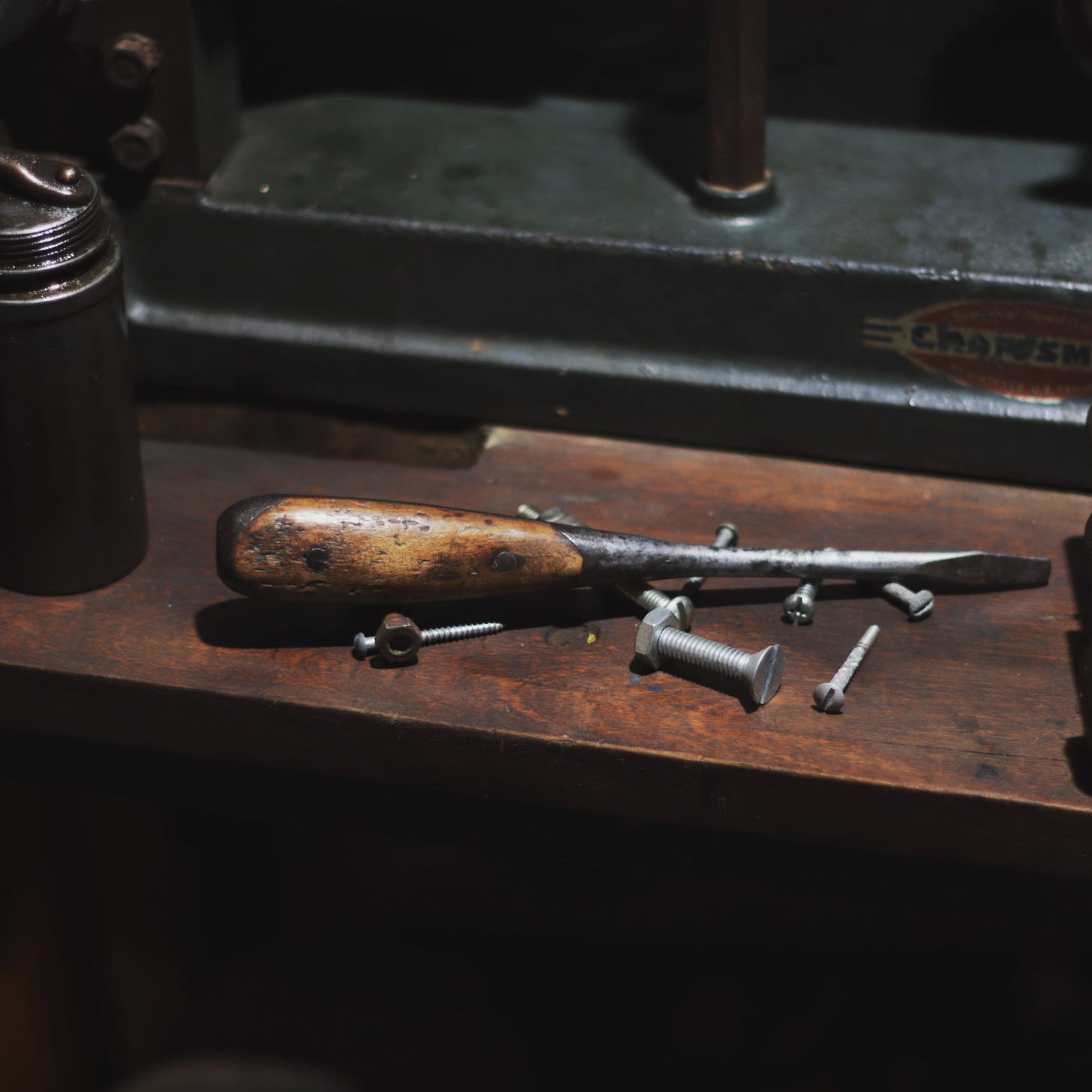 Image of an antique screwdriver on a workbench.