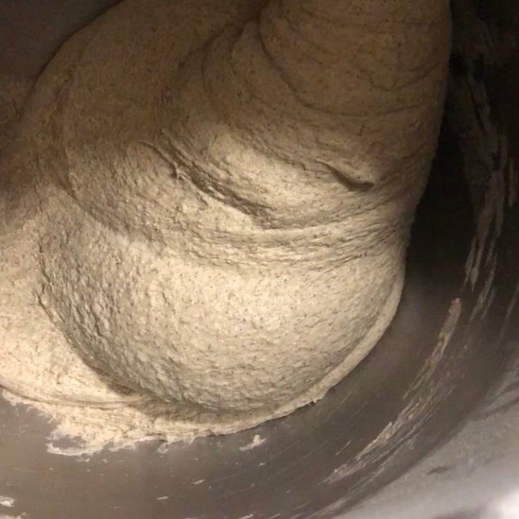 Dough climbing up the dough hook as it mixes.