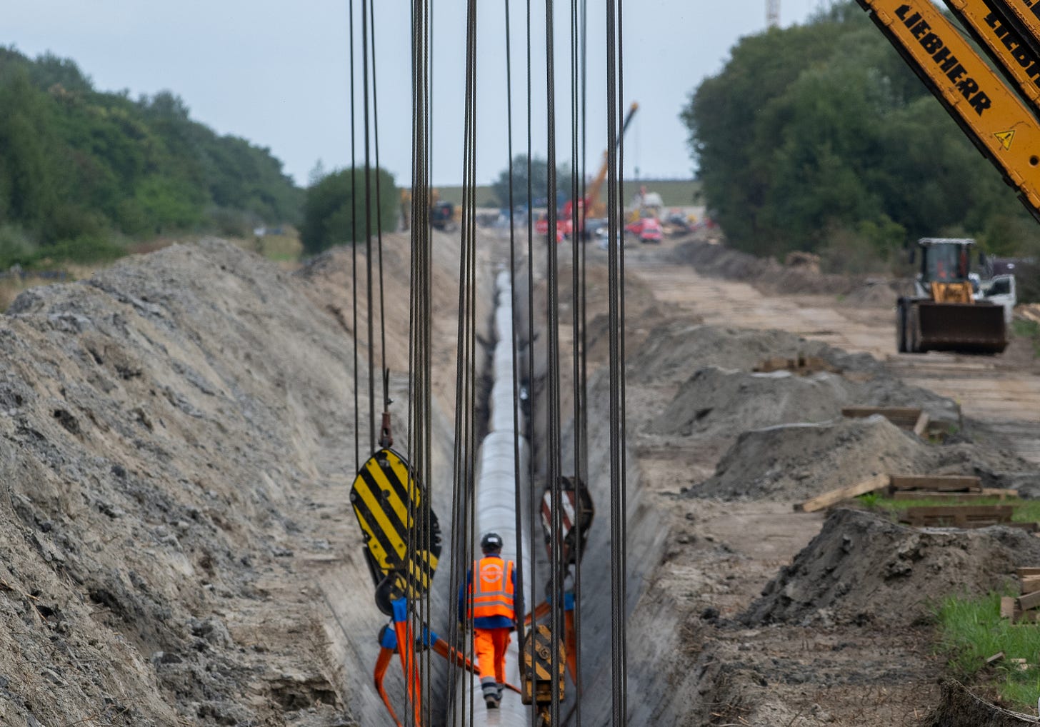 Workers construct a pipeline for transporting natural gas on September 14, 2022 near Wilhelmshaven, Germany. (Photo by David Hecker/Getty Images).