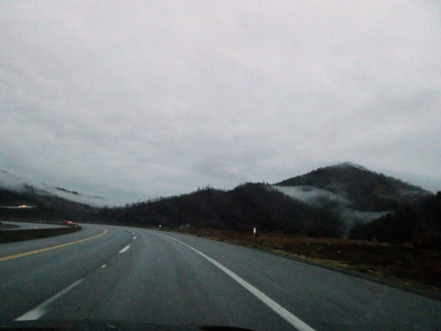 Freeway with hills and mist