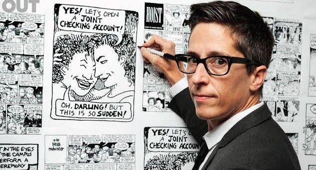 Photo of Alison Bechdel in front of enlarged strips from Dykes to Watch Our For. Bechdel is holding a pen, as if drawing one of the strips, facing towards the camera. She is a white woman with short, dark brown hair and square glasses. She has on a grey suit and white shirt with a black tie. 