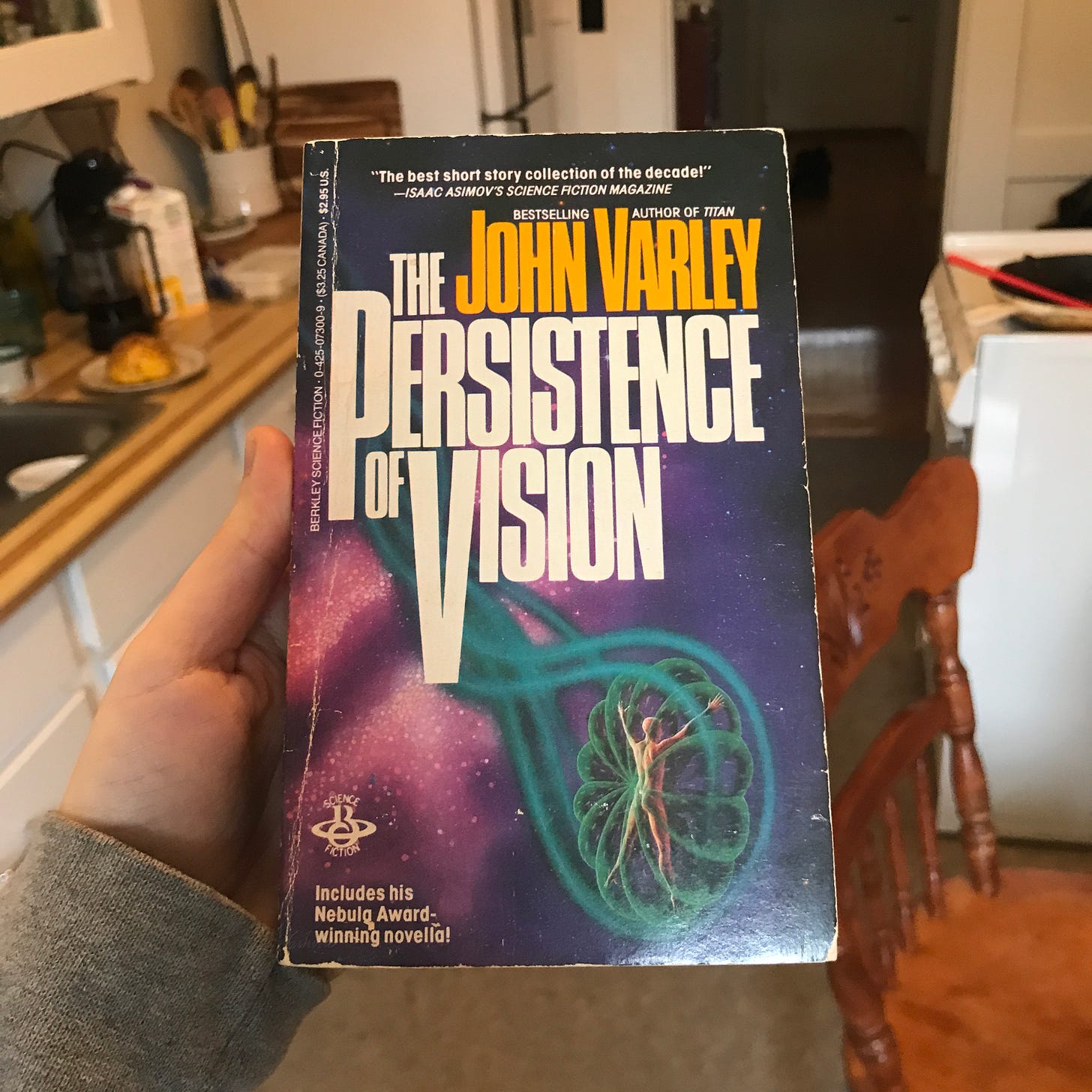 I’m holding a copy of John Varley’s short story collection “The Persistence of Vision.” 