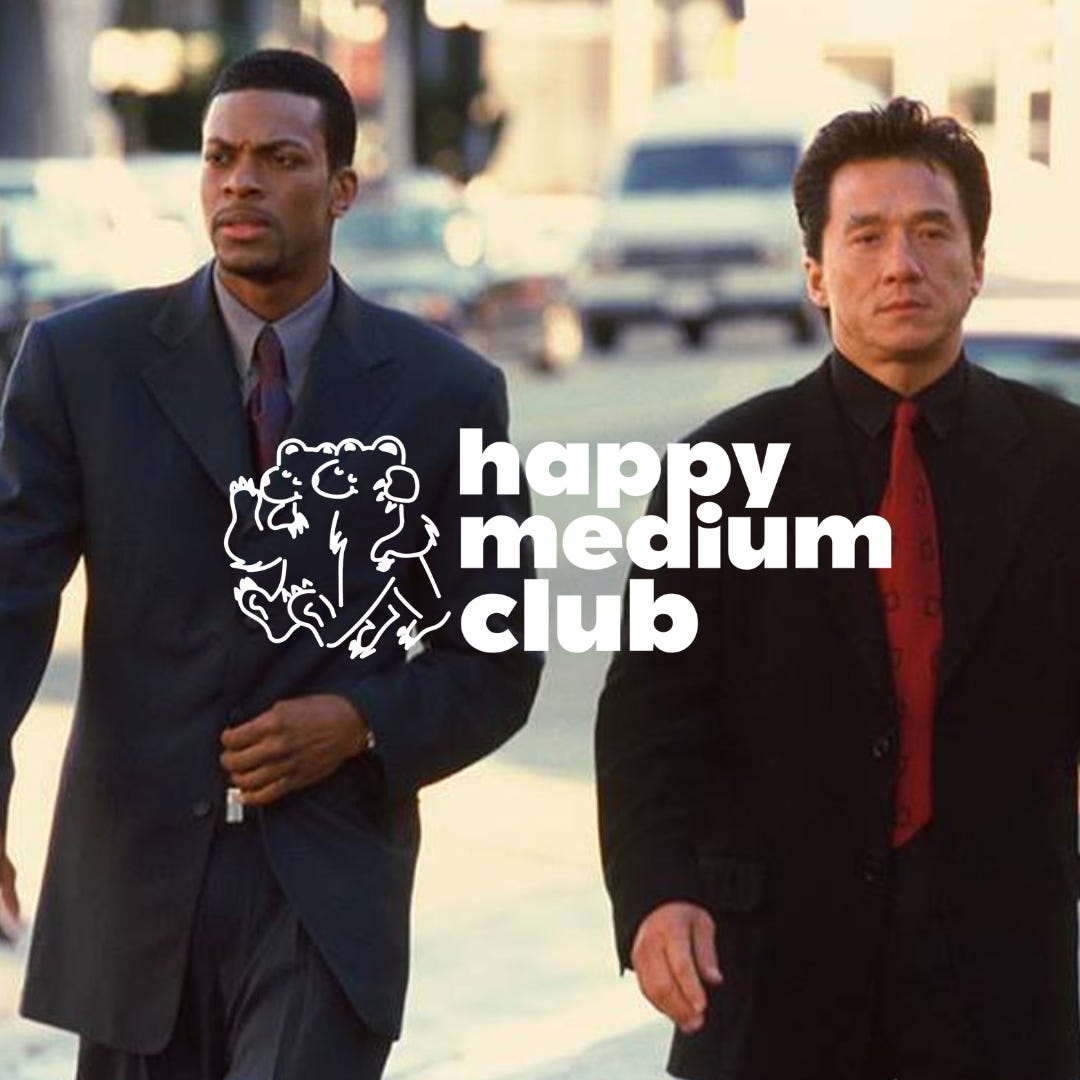 A still from Rush Hour, featuring Jackie Chan and Chris Tucker. The Happy Medium Club logo is overlaid.