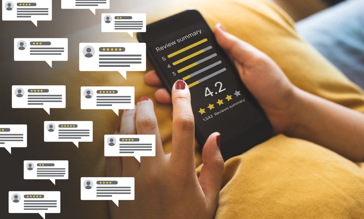 Person holding mobile device that says “Review Summary” 4.2 followed by four stars and a part of a fifth star shaded in, 1542 reviews submitted with numerous review comments in thought bubbles on the left side