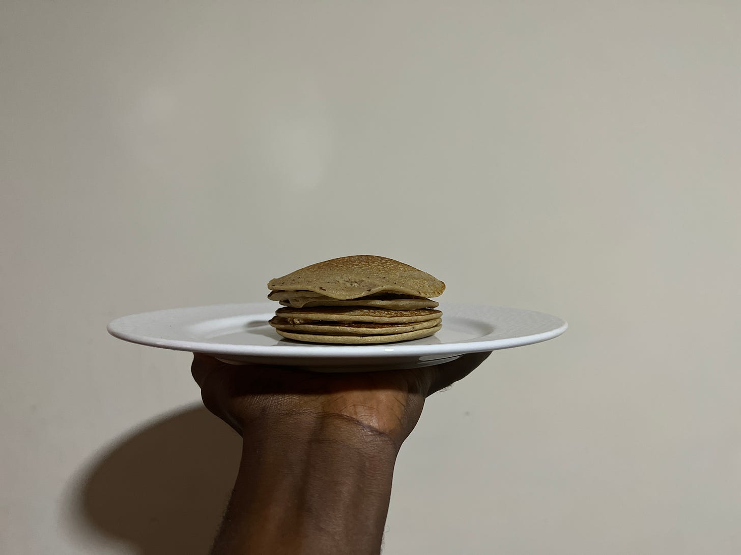 Banana-apple-sesame pancakes layered atop each other on a plate