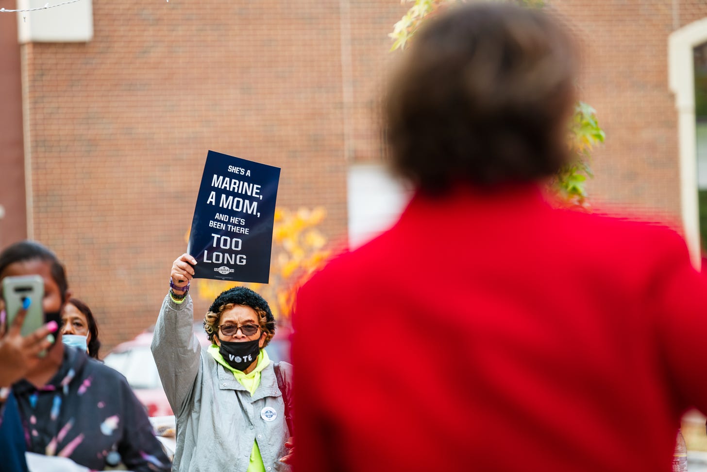 LOUISVILLE, KY - OCTOBER 17: A woman waves her sign in support of Amy McGrath, Kentucky Democratic Senate Candidate, as McGrath addresses constituents at the Early Vote Cookout at a local restaurant on October 17, 2020 in Louisville, Kentucky. Amy McGrath aims to unseat Senate Majority Leader Mitch McConnell in 2020 general election. (Photo by Jon Cherry/Getty Images)
