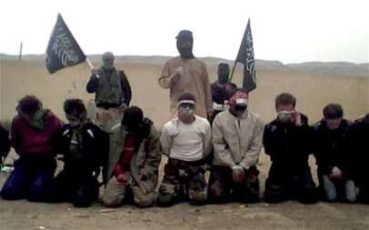 Blindfolded and bound men kneel as three terrorists loom behind them