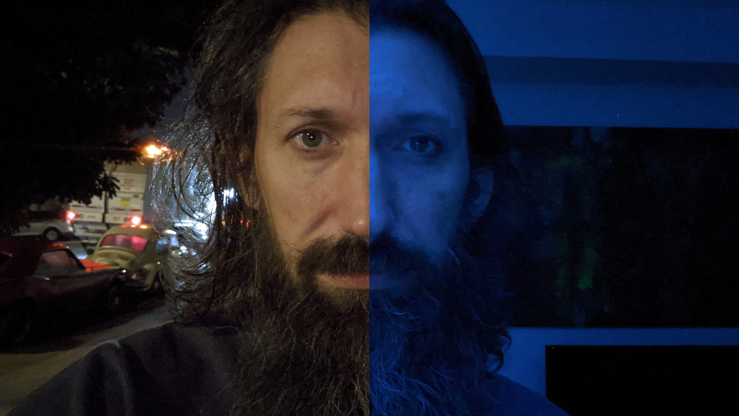 A close-up selfie of me looking straight into the camera with disheveled hair. The left half is taken outside with a garbage truck in the background. The right side is taken inside with a blue light on. 