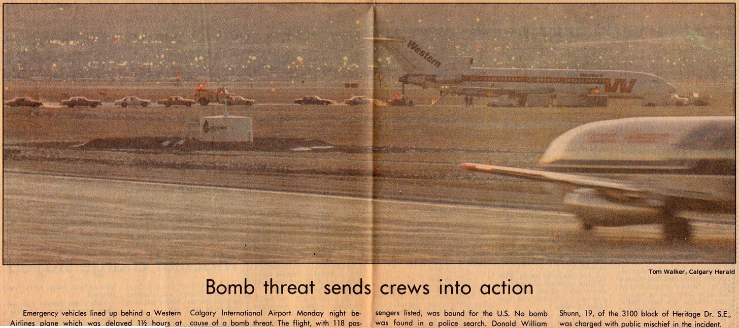 In a yellowed newspaper clipping, the caption "Bomb threat sends crews into action" appears below a page-wide photograph of a Western Airlines passenger jet sitting on a distant runway with nine or ten emergency response vehicles lined up behind it.