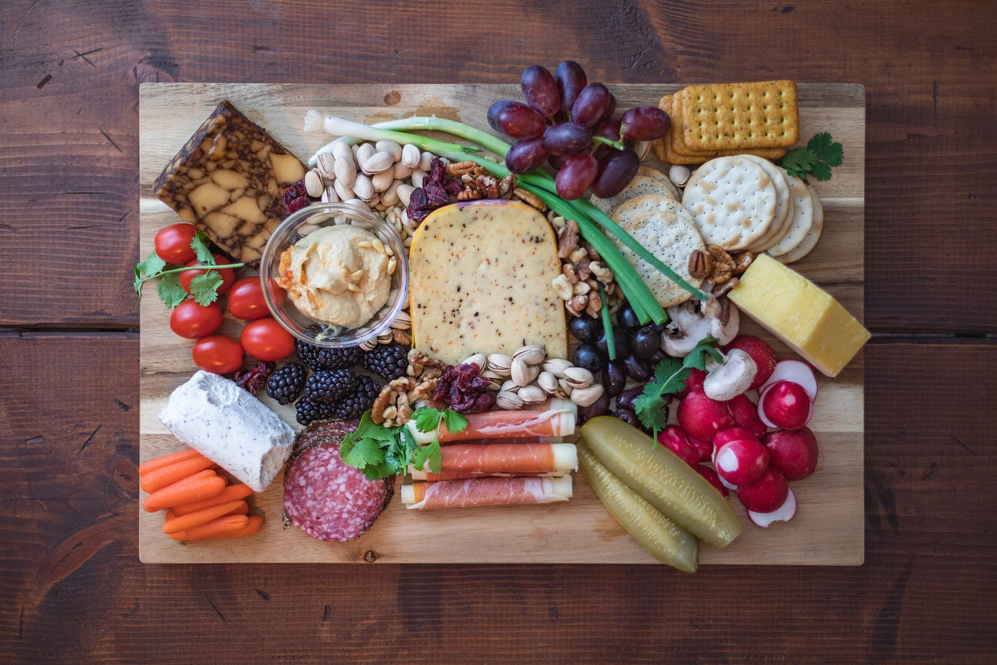 Photo of a charcuterie board with meat, cheese, and fruits