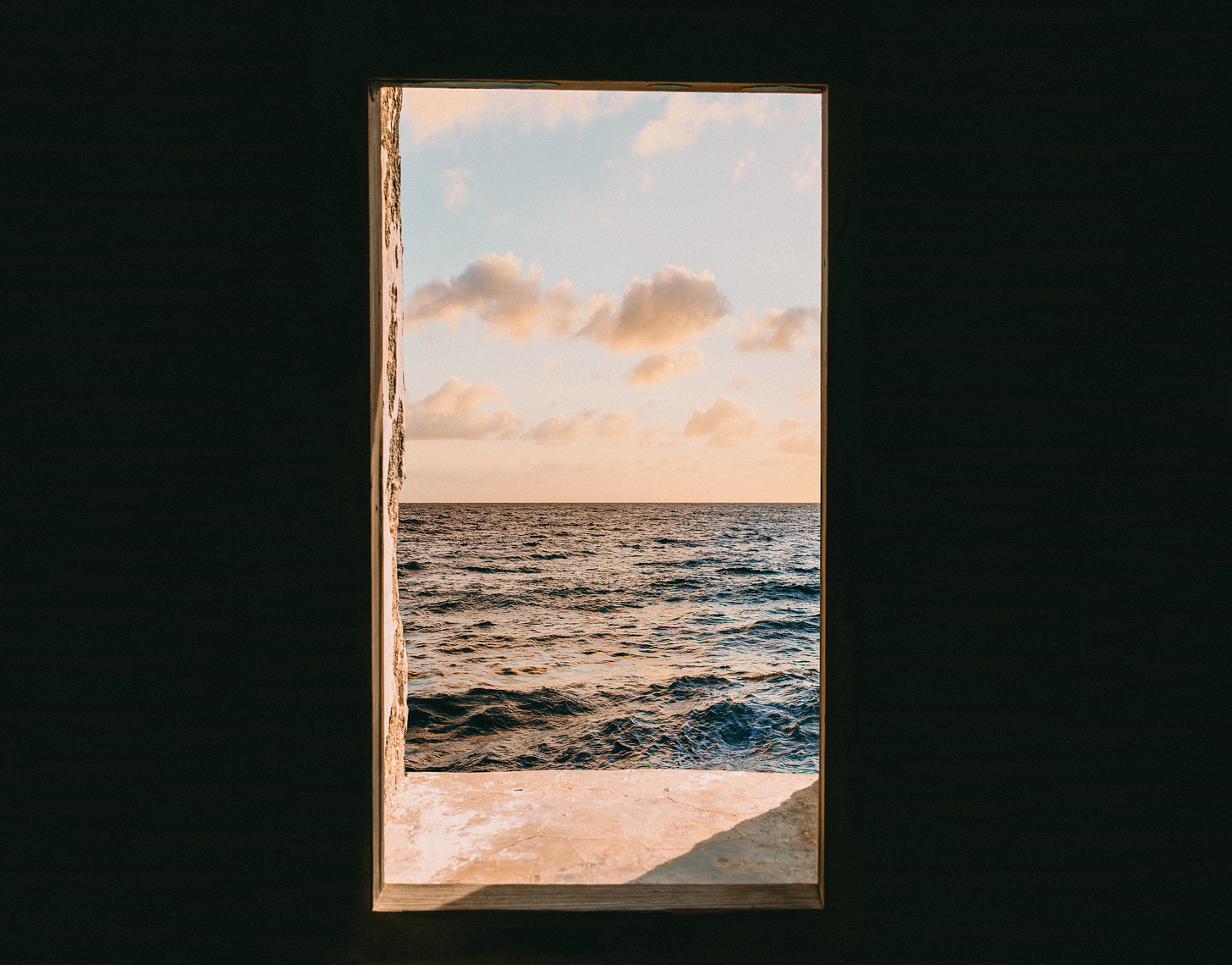 the sea and sky through a rectangular opening