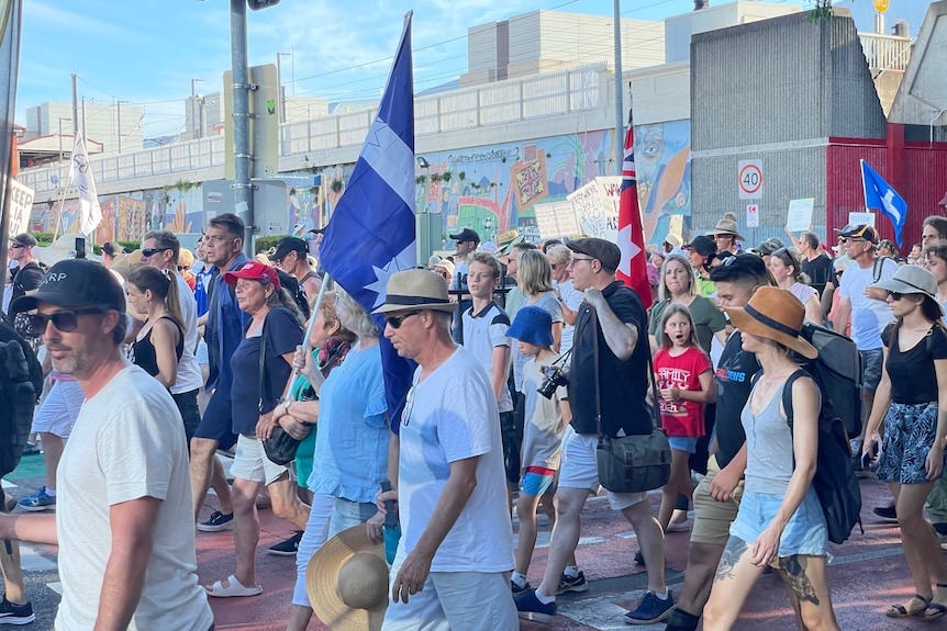 Protesters march through South Brisbane.