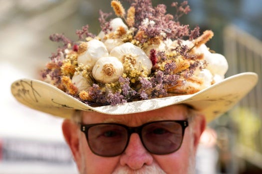Gerry Foisy poses for a portrait with his homemade hat at the Gilroy Garlic Festival on Friday, July 27, 2018 in Gilroy, Calif. Foisy is known around town as Mr. Garlic and held the title for many years before retiring in 2016. (Photo by Maritza Cruz/Bay Area News Group Archives)