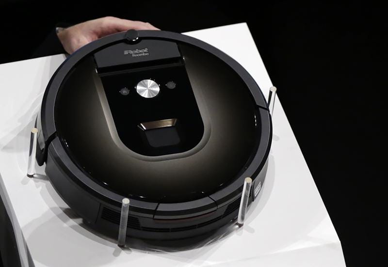 FILE - A Roomba 980 vacuum cleaning robot is presented during a presentation  in Tokyo, Tuesday, Sept. 29, 2015. Amazon on Friday, Aug. 5, 2022, announced it has entered into an agreement to acquire the vacuum cleaner maker iRobot for approximately $1.66 billion. The company sells its robots worldwide and is most famous for the circular-shaped Roomba vacuum.  (AP Photo/Eugene Hoshiko)
