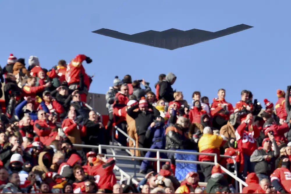 FILE - A B-2 bomber flies over spectators at Arrowhead Stadium before an NFL AFC Championship football game between the Kansas City Chiefs and the Tennessee Titans, Jan. 19, 2020, in Kansas City, Mo. The Air Force has grounded its entire fleet of B-2 stealth bombers following an emergency landing and fire earlier this month, and none of the strategic aircraft will perform flyovers at this years' college bowl games. (AP Photo/Ed Zurga, File)