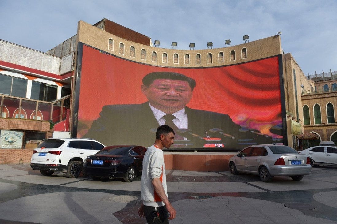 A man walking past a screen showing images of China's President Xi Jinping in Kashgar in China's northwest Xinjiang region. More than one million ethnic Uygurs and other mostly Muslim minorities are believed to be held in a network of internment camps that Beijing describes as “vocational education centres. Photo: AFP