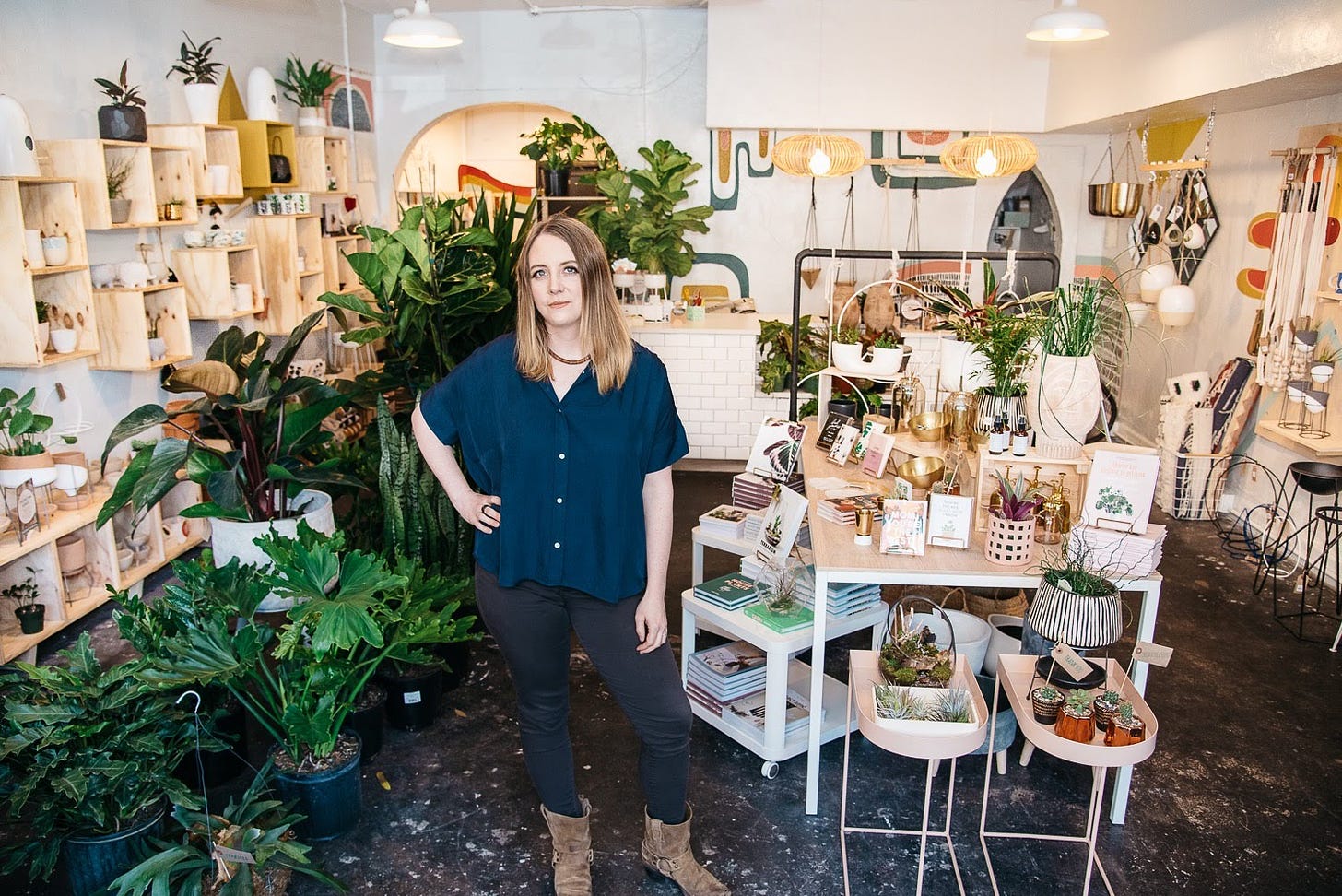person standing in the middle of a retail shop with lots of plants