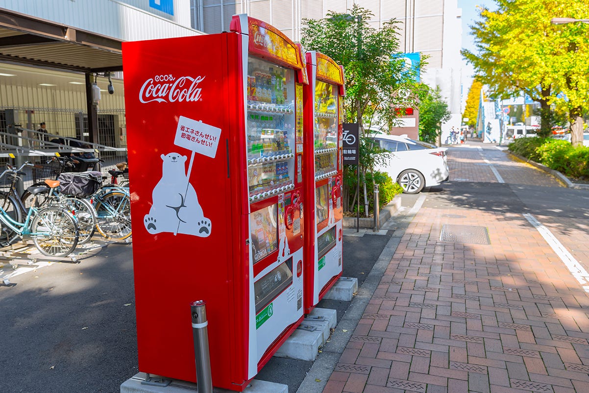 A red vending machine on the sidewalk

Description automatically generated with low confidence