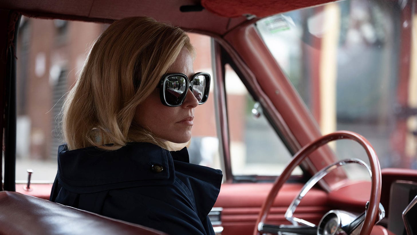 Elizabeth Banks sitting in a car with sunglasses on in a still from Call Jane