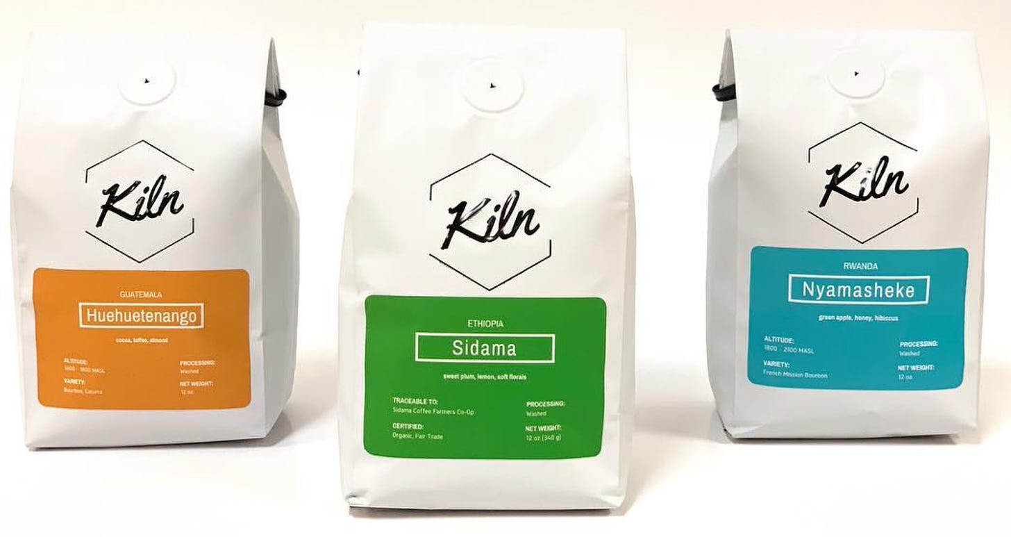Close up of three white coffee bags on a white background lined up side-by-side.
