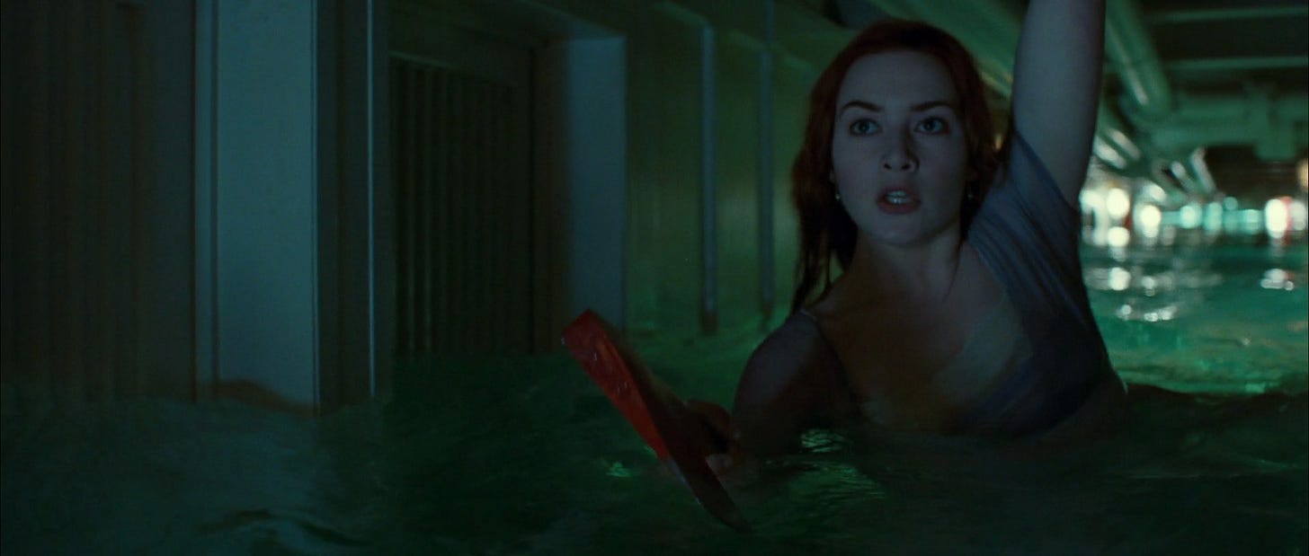 Rose wading through chest-deep water with an axe in hand