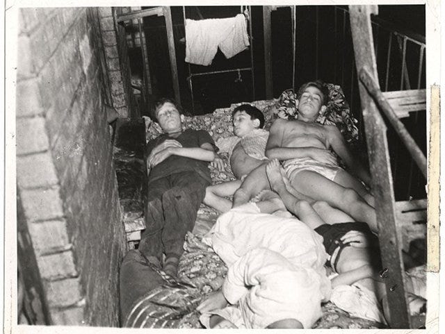 "View of members of a family as they sleep outside on the fire escape of their tenement building, July 27, 1940." (Photo by Weegee [Arthur Fellig] / International Center of Photography)