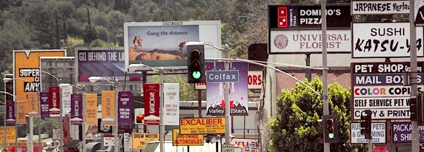 An image of the roadside billboards and marketing signage on Colfax in LA.