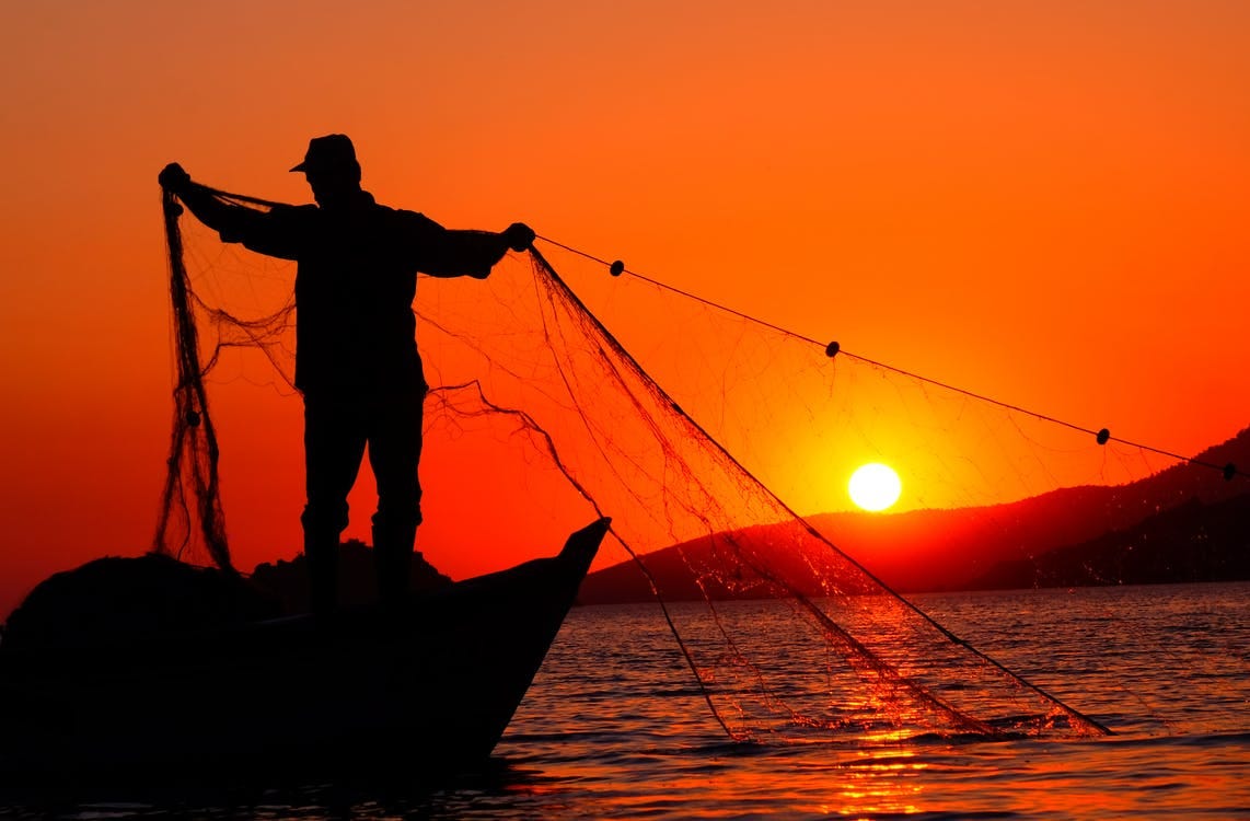 Free Silhouette Photo of a Man Holding a Fish Net Stock Photo